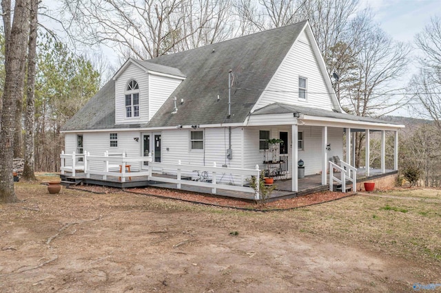 view of front facade with covered porch and roof with shingles