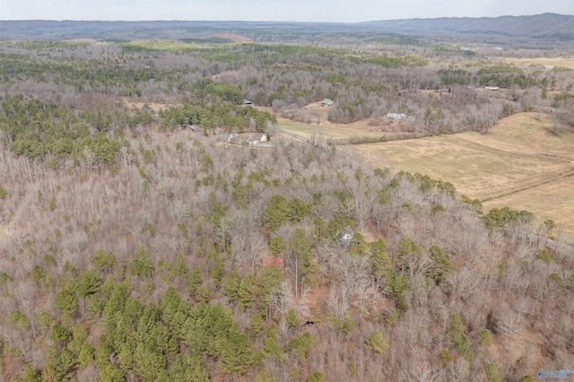 drone / aerial view featuring a wooded view