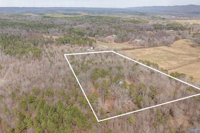 birds eye view of property with a view of trees