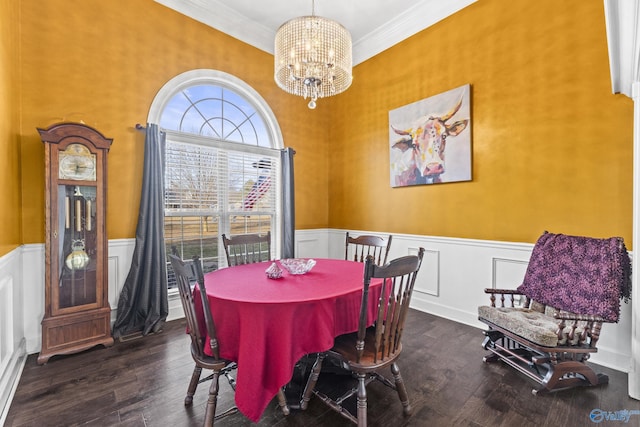 dining space featuring dark hardwood / wood-style flooring, a notable chandelier, and ornamental molding