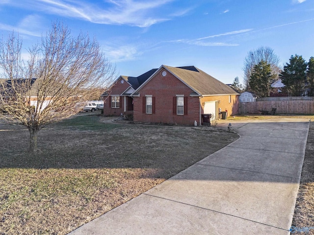 view of home's exterior with a yard and a storage unit