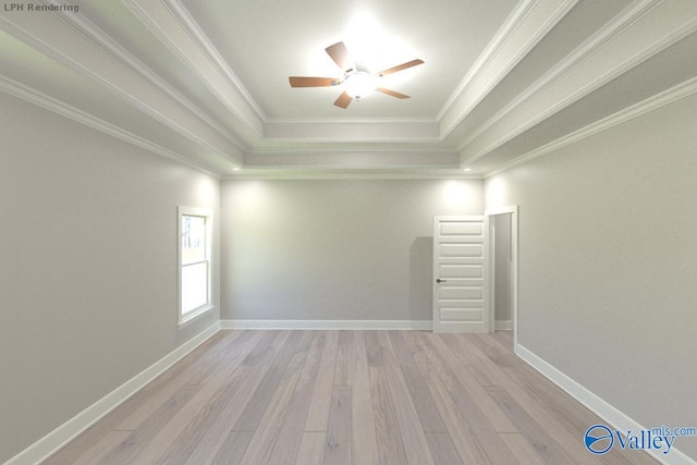 spare room featuring crown molding, a tray ceiling, and light hardwood / wood-style flooring