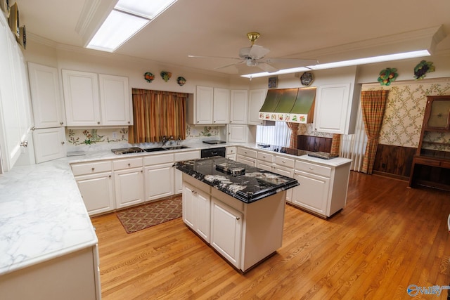 kitchen featuring white cabinetry, custom exhaust hood, light hardwood / wood-style flooring, and a kitchen island