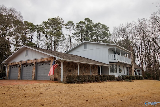 front of property with a balcony and a garage