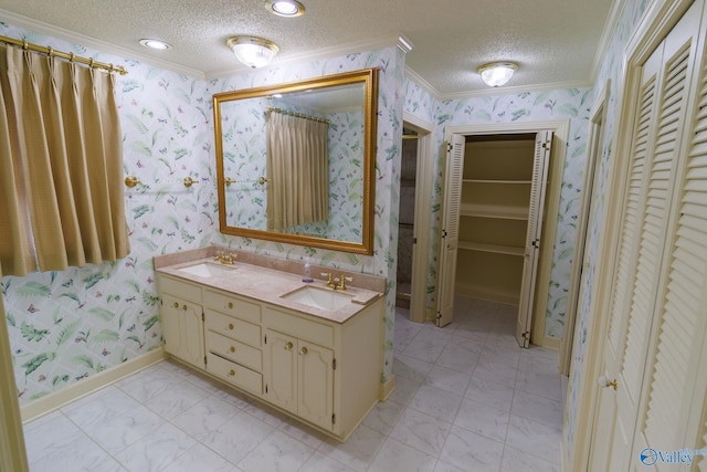 bathroom with vanity, ornamental molding, and a textured ceiling