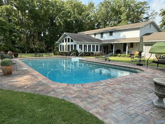 view of pool featuring a yard and a patio area