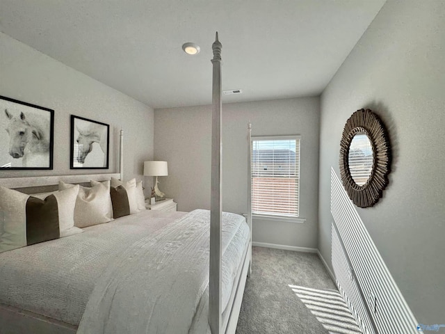 carpeted bedroom with baseboards and visible vents