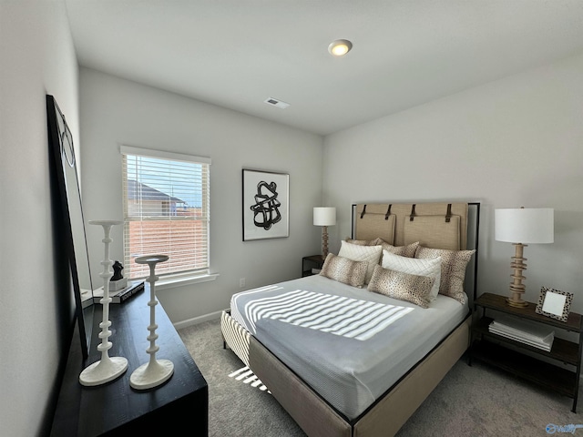 carpeted bedroom with baseboards and visible vents