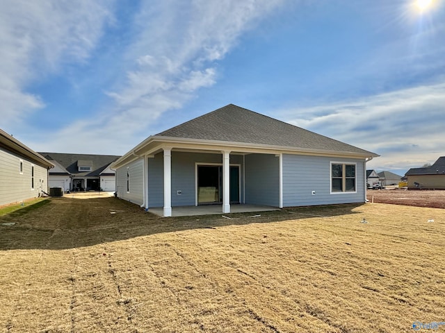 back of house with a patio, a shingled roof, and central AC