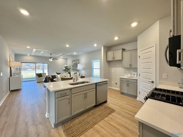 kitchen with gray cabinets, a sink, and stainless steel dishwasher