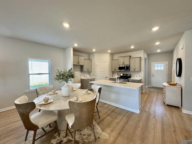 dining space featuring sink and light hardwood / wood-style floors