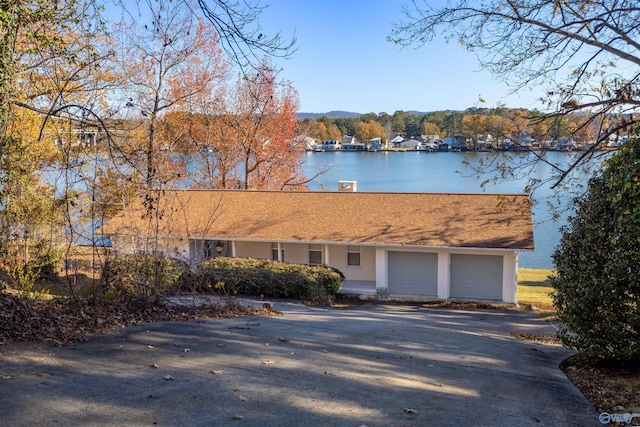 view of front facade with a water view and a garage