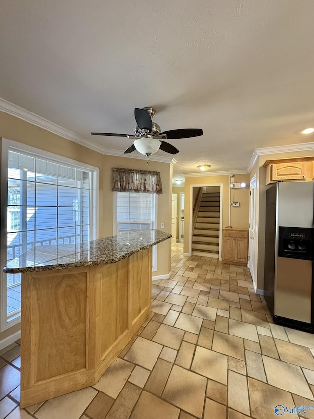 kitchen featuring stainless steel refrigerator with ice dispenser, crown molding, light brown cabinets, and light stone counters