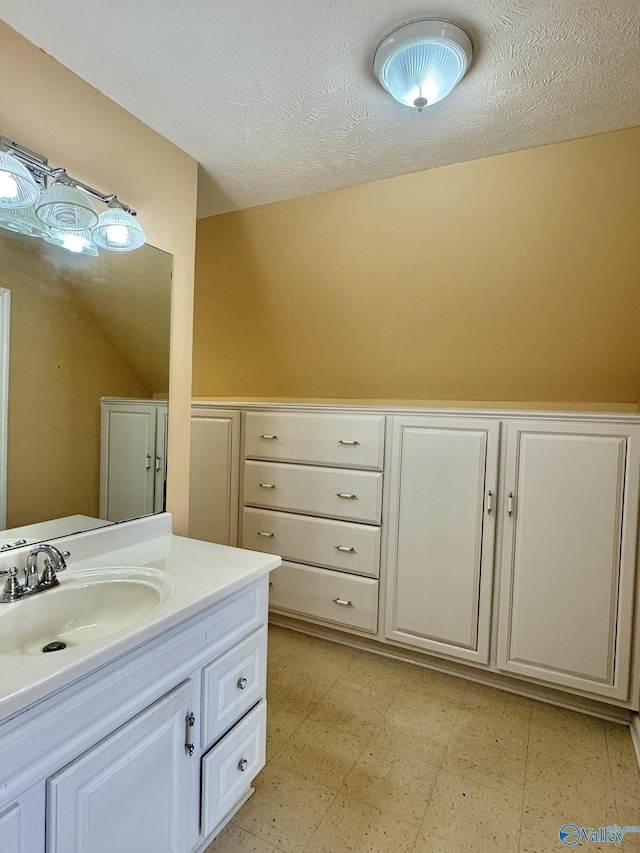 bathroom featuring vanity and a textured ceiling