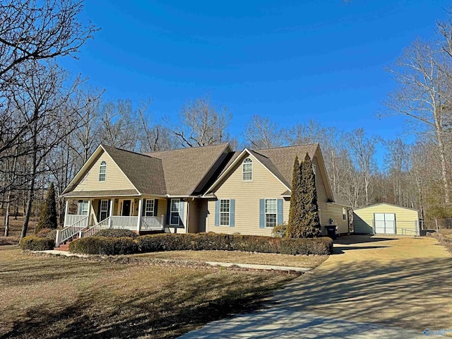 view of front of home with an outbuilding, a garage, and covered porch