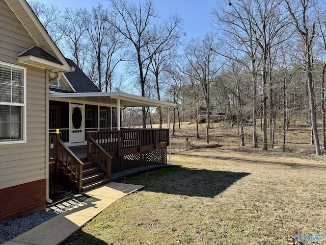 view of yard featuring a wooden deck and a sunroom