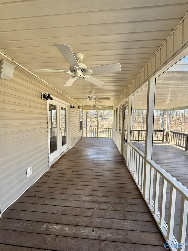 wooden deck with french doors, ceiling fan, and covered porch