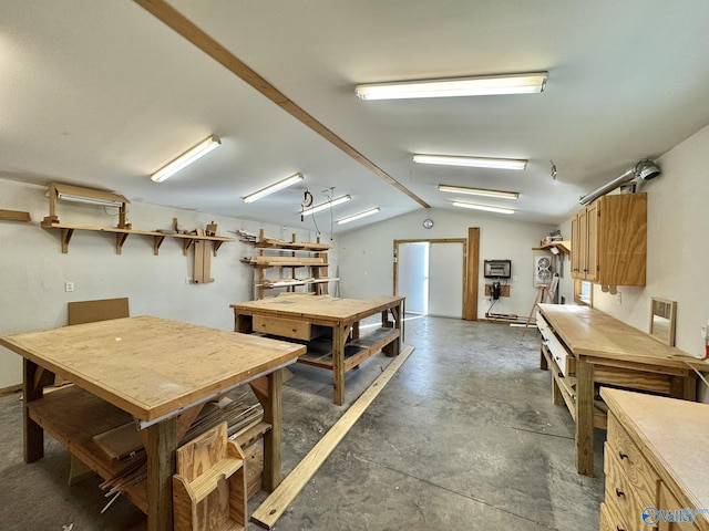 interior space featuring lofted ceiling and a workshop area