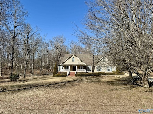 view of front of house featuring covered porch and a front yard