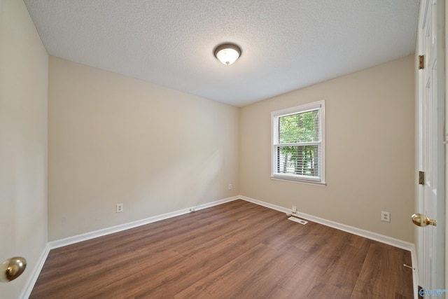 2010 Burlington Dr SE, Huntsville, AL 35803 - empty room with dark wood-type flooring and a textured ceiling
