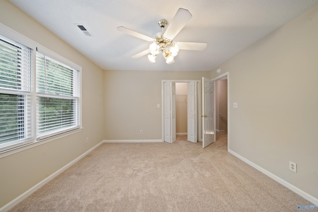 2010 Burlington Dr SE, Huntsville, AL 35803 - unfurnished bedroom with light colored carpet and ceiling fan