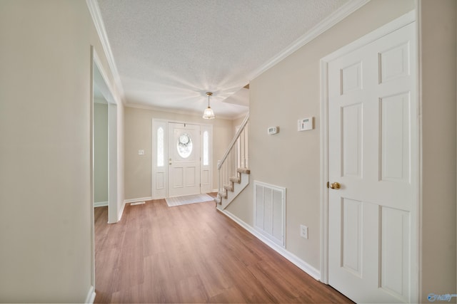 2010 Burlington Dr SE, Huntsville, AL 35803 - entryway with a textured ceiling, ornamental molding, light wood-style flooring, and stairway