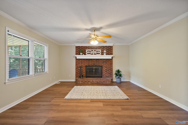 2010 Burlington Dr SE, Huntsville, AL 35803 - unfurnished living room featuring a ceiling fan, crown molding, wood finished floors, and a fireplace