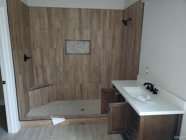 bathroom featuring walk in shower, vanity, and hardwood / wood-style flooring