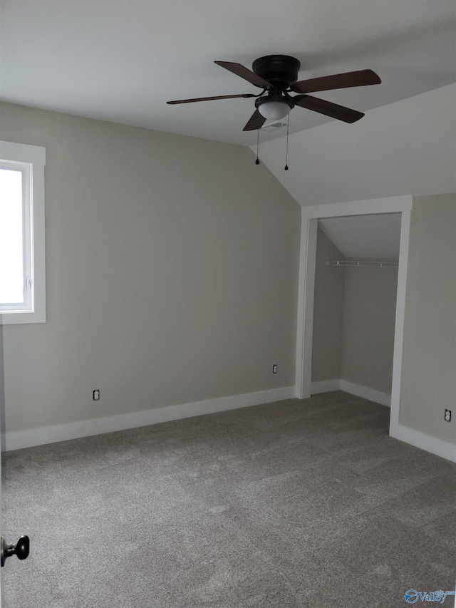interior space featuring carpet floors, ceiling fan, and lofted ceiling