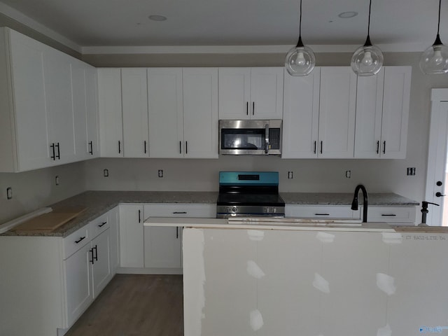 kitchen featuring white cabinets and appliances with stainless steel finishes