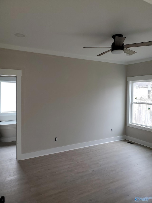 unfurnished room featuring ceiling fan, crown molding, and hardwood / wood-style floors