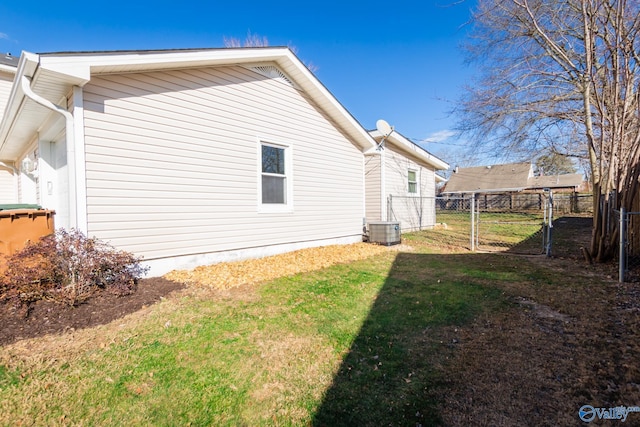 view of side of home featuring a yard and central air condition unit