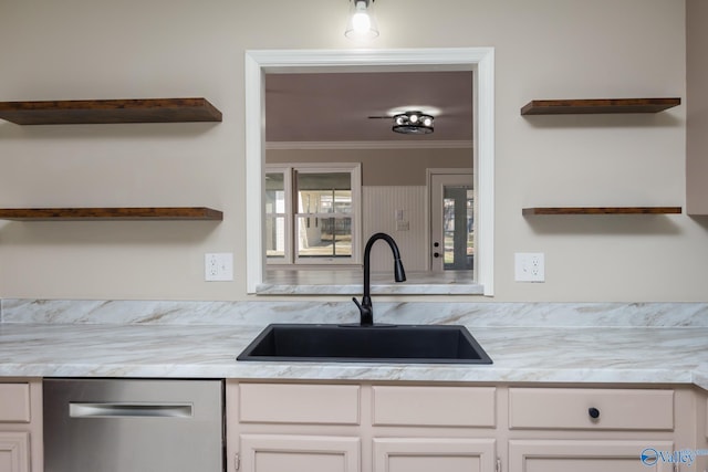 kitchen with white cabinetry, ornamental molding, sink, and stainless steel dishwasher