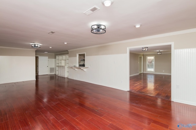 unfurnished living room with crown molding and wood-type flooring