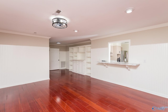 unfurnished living room featuring crown molding and dark wood-type flooring