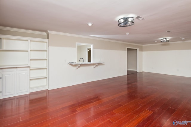unfurnished living room with crown molding and dark wood-type flooring