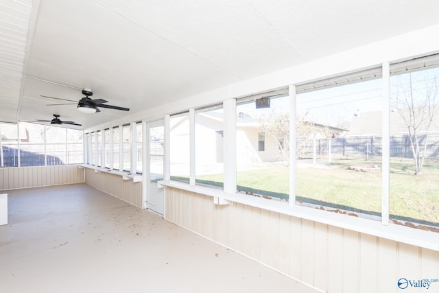 unfurnished sunroom featuring ceiling fan