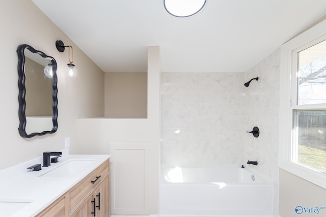 bathroom with vanity and tiled shower / bath combo