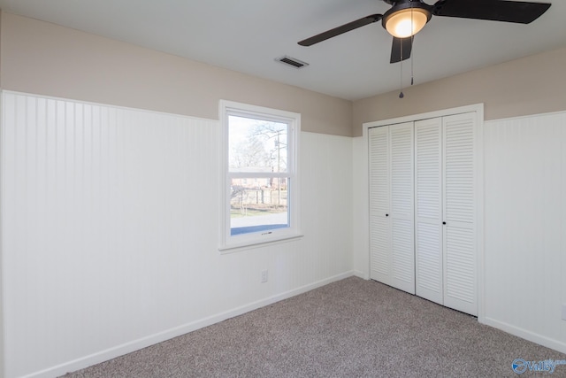 unfurnished bedroom with light carpet, ceiling fan, and a closet