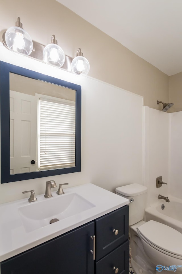 full bathroom featuring vanity, bathtub / shower combination, and toilet