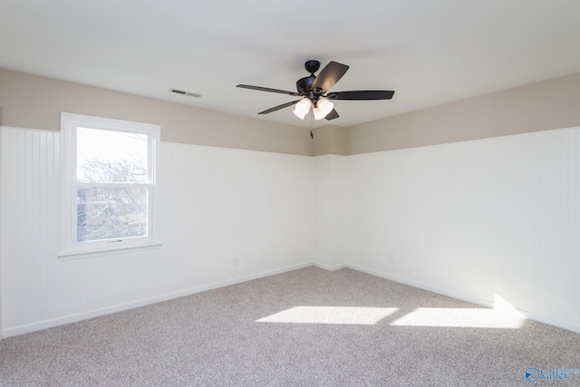 empty room with ceiling fan and carpet flooring