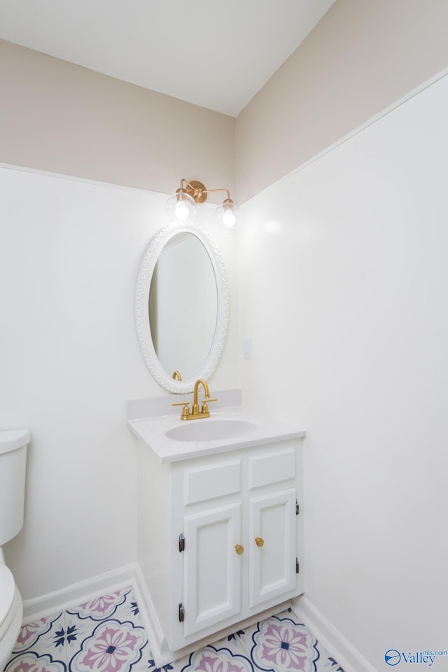 bathroom with vanity, tile patterned floors, and toilet