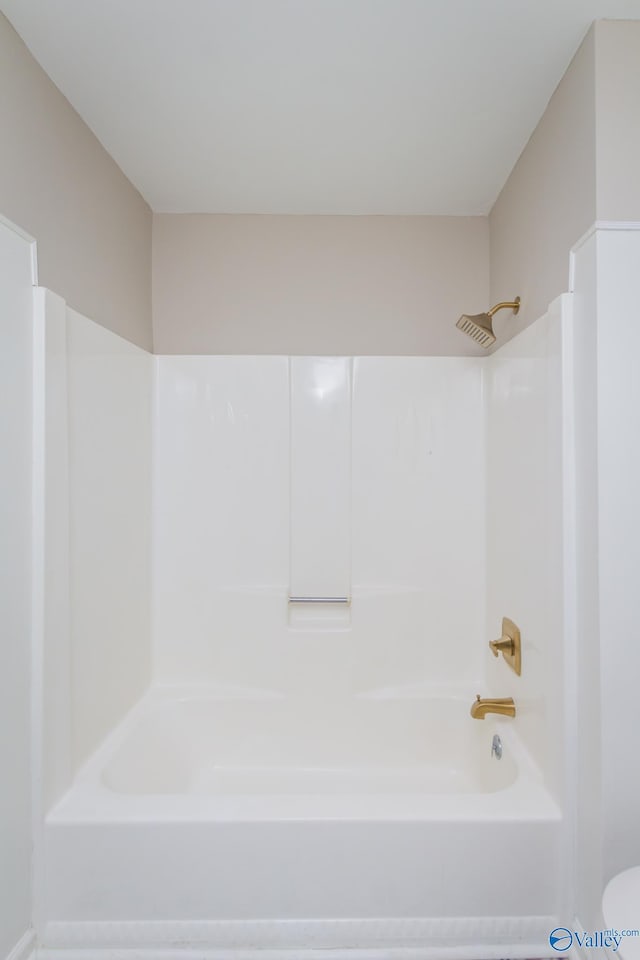 bathroom featuring toilet and shower / bath combination