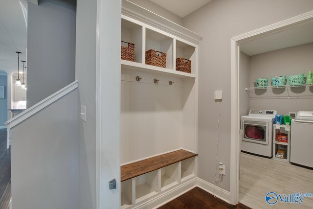 mudroom with washer and clothes dryer and wood-type flooring