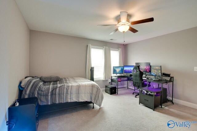 bedroom featuring ceiling fan and carpet