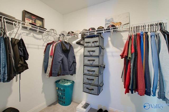 walk in closet featuring carpet