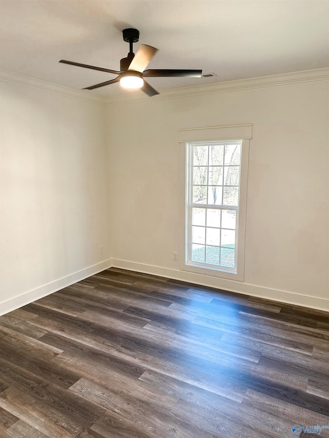 spare room featuring dark wood-type flooring, ornamental molding, and ceiling fan