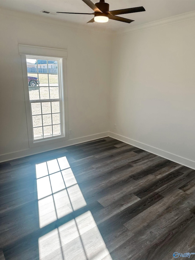 empty room with ceiling fan, dark hardwood / wood-style floors, and ornamental molding