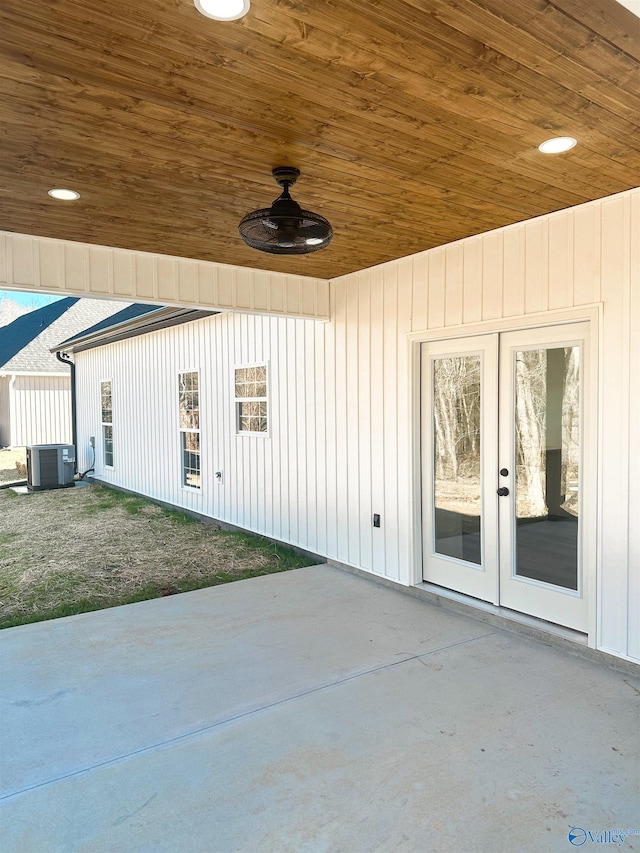 entrance to property with ceiling fan, a patio area, and central AC