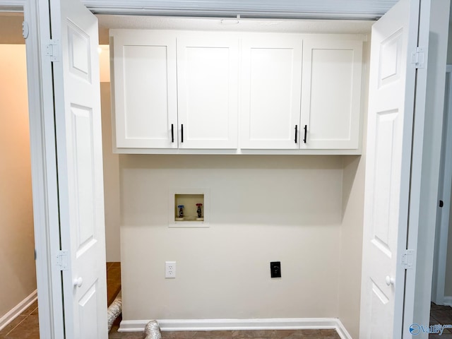 laundry room featuring washer hookup, electric dryer hookup, cabinet space, and baseboards